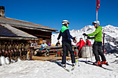 Skiers arriving at alpine restaurant, Alp Fops, Lenzerheide, Canton of Graubuenden, Switzerland