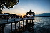Pavilion with bar on the shore of Lake Constance at sunset, Bregenz, Vorarlberg, Austria