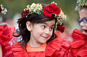 Young girl with flowers in her hair at the Madeira Flower Festival parade, Funchal, Madeira, Portugal