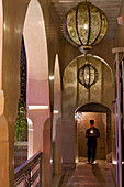 Young man walking with moroccan tea and a candle, Riad Anayela, Marrakech, Morocco