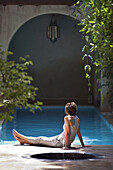 Woman relaxing by the pool, El Fenn, Marrakech, Morocco