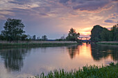 Sunset over the Trebel with wooden bridge in the distance, Nehringen, Mecklenburg Western Pommerania, Germany