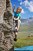 A girl bouldering, climbing, Engstligenalp, Bernese Oberland, Switzerland