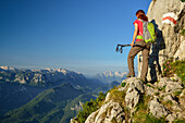 Woman ascending on path Steinerne Jaeger to Hochstaufen, Reiteralm and Loferer Steinberge in background, Chiemgau Alps, Chiemgau, Upper Bavaria, Bavaria, Germany