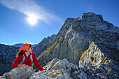 Woman ascending to Hochkalter, Berchtesgaden National Park, Berchtesgaden Alps, Upper Bavaria, Bavaria, Germany