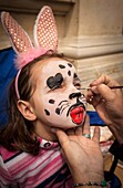 Girl having face painted, Victorian festival, historic precinct, Oamaru, Otago