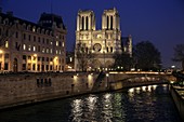 The night view of Notre Dame Cathedral with River Seine in foreground  Paris  France.