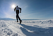 9th Lake Baikal Ice marathon in Siberia, Russian Federation March 3 2013  Marathon competitor running toward the finish line on the distant far shore of Lake Baikal