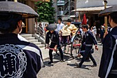 rickshaw carrying a priest,in Senso-ji Temple during Sanja Matsuri Asakusa Tokyo city, Japan, Asia