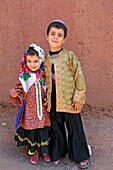 Portrait of young iranian girl and boy wearing a chador, Iran