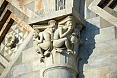 Grotesque Medieval pillar capital sculpture on the exterior of the Duomo Pisa