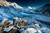 Snow covered boulders on Ball hut ridge, pre-dawn light, Tasman glacier below, Aoraki Mount Cook National Park, Canterbury