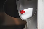 female mannequin with red lipstick in shop window in rome italy