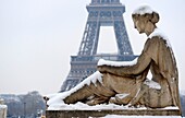 Statue under the snow and Eiffel tower in Paris Trocadero,France,Europa