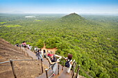 Sri Lanka - Sigiriya, tourists on stairs of Lion´s Gate to the ancient fortress, ancient Royal Fortress in Sri Lanka, UNESCO World Heritage Site