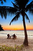 Tourists resting, Thailand Beach after sunset, Koh Samet Island, Thailand