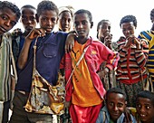 A group of local children making faces and posing for the camera