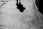 Woman's Shadow on Sidewalk