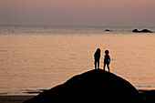 Girl and Boy on Rock by Sea, Silhouette