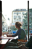 Woman Sitting at Café Table, Italy