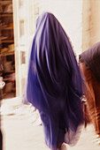 Woman Wearing The Haik, Big Veil That Covers The Head And Body, Going To The Bazaar Of Marrakech, Morocco, Africa