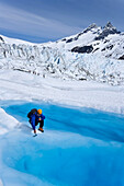 Hiker Explores The Surface Of Mendenhall Glacier Near Juneau. Summer In Southeast Alaska.