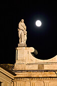'Italy, Emilia-Romagna, Statue On Top Of Church With Full Moon; Parma'