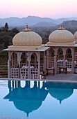 Swimming pool with rooftop pavilions for dining in a hotel, Udaipur, Rajasthan, India