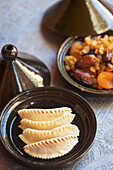 Traditional pastries and dried fruits served in small tagines in Dar Ahlam Hotel, Skoura, Morocco