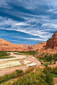 River and small village in background, Valley of Roses, Morocco