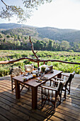 Breakfast table set up on porch at Kitich Safari Camp, Mathews Mountain Range, Kenya