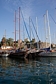 Turkey, behind is Bodrum castle, Bodrum, Gulet boats lined up in harbour of Bodrum bay