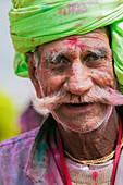 Portrait of Indian Hindu man celebrating Lathmar Holi, Barsana, Uttar Pradesh, India