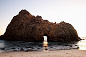 California, Big Sur, Pfeiffer Beach, Close up view of arch in rock formation, Long exposure.