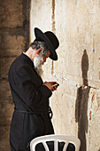 Side view of man praying at Wailing Wall, Jerusalem, Israel