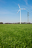 Wind turbine and electricity pylon, Dortmund, North Rhine-Westphalia, Germany
