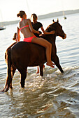 Girls with a horse in lake Starnberg, Ammerland, Munsing, Upper Bavaria, Germany