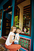Mother and son looking at a shop window of an antique shop, Chinatown, Singapore