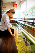 Woman and boy enjoying fish spa, Downtown Core, Singapore