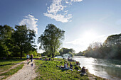 People sitting at river Isar, Flaucher, Munich, Bavaria, Germany