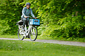 Man cycling with an E-bike along lake Starnberg, Upper Bavaria, Germany