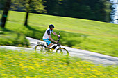 Pedelec cyclist on the way, Upper Bavaria, Germany