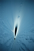 Mountaineer at entrance to the Imax Crevasse, large dangerous crevasse requires ropes and guides, Antarctica