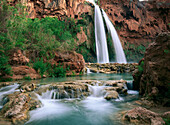 Havasu Creek which is lined with Cottonwood trees, being fed by one of its three cascades, Havasu Falls, Grand Canyon, Arizona