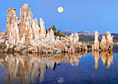 Full moon over Mono Lake with wind and rain eroded tufa towers and the eastern Sierra Nevada Mountains in the background, California