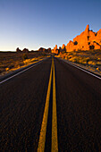 Road through red sandstone rocks at sunset, Arches National Park, Utah