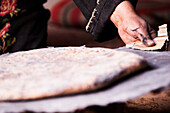 Bedouin woman baking bread, Wadi Rum, Jordan, Middle East