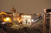 The columns of the Temple of Saturn, Arch of Septimius Severus and the medieval church in the Roman Forum, Rome, Italy