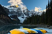 Rows of multi colored canoes at Moraine Lake, Banff National park, Canada