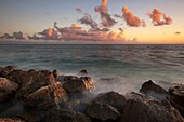 Rocky beach shoreline during sunset at Key West, Florida, USA